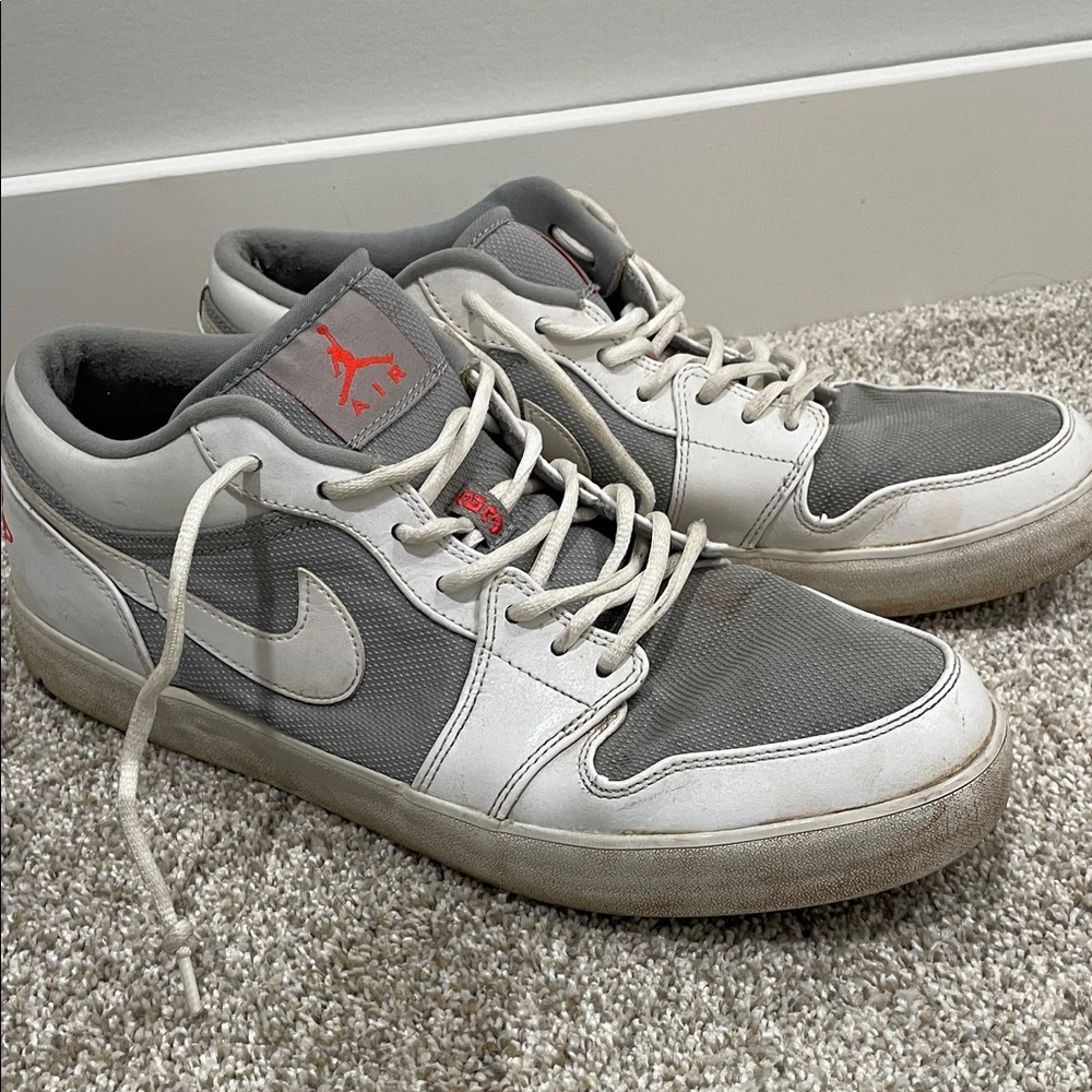 Nike Air Jordan’s Low-Top Sneakers in Gray, White and Red Accents